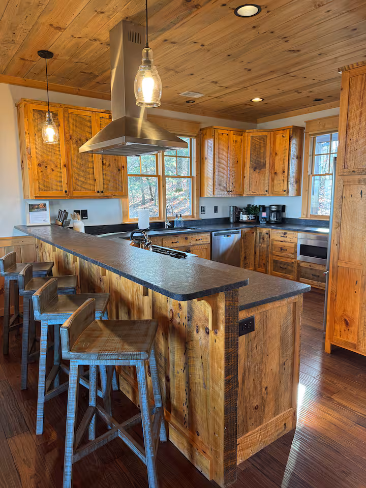 Primary bedroom with king bed and wood paneling