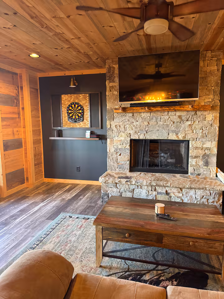 Bedroom with wood-paneled walls and cozy white linens