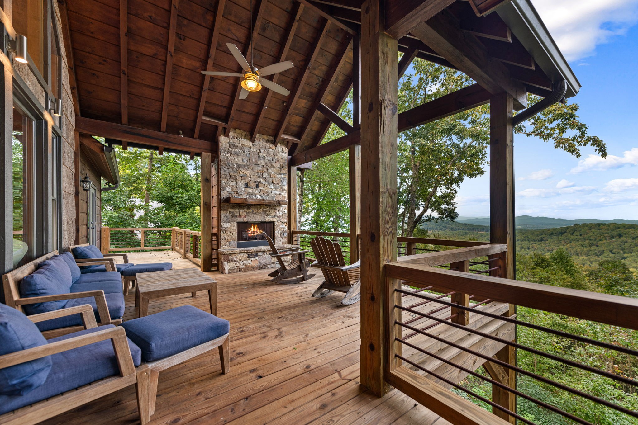 Covered deck with outdoor fireplace and mountain views