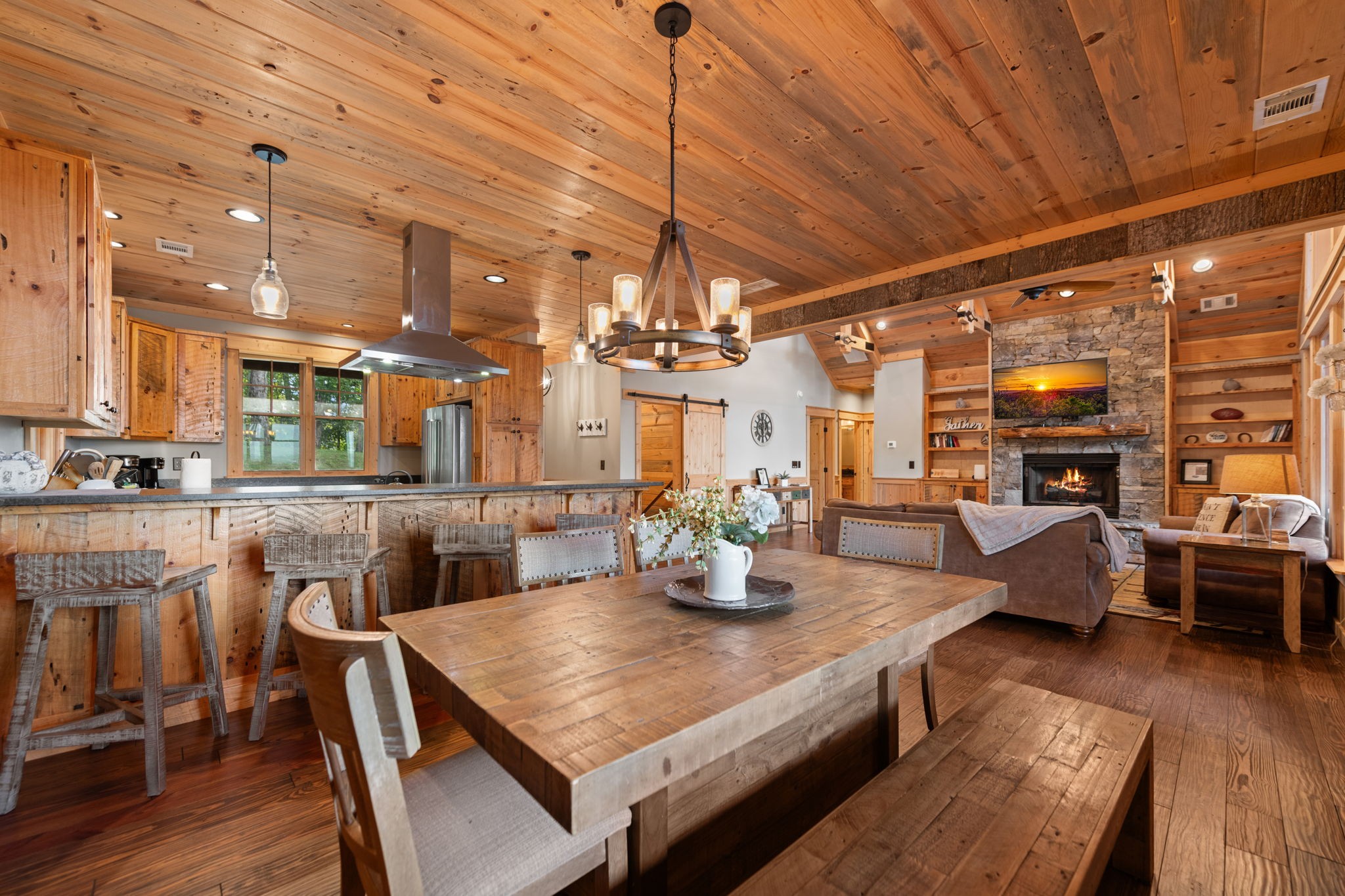 Open kitchen and dining area with rustic wood finishes