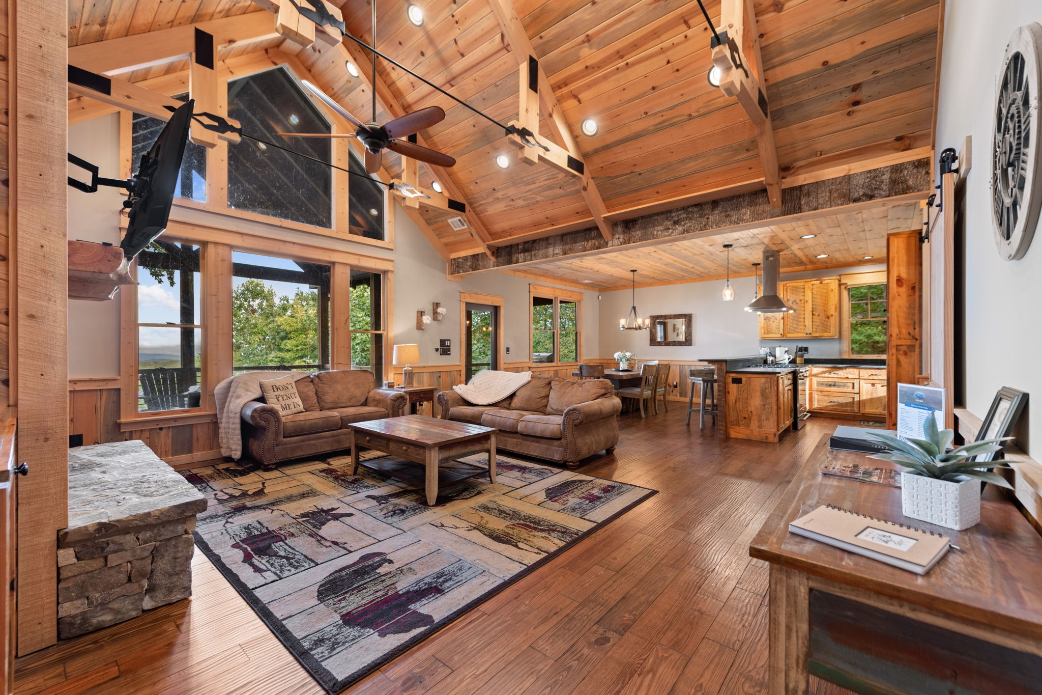 Spacious vaulted living room with large windows and mountain views