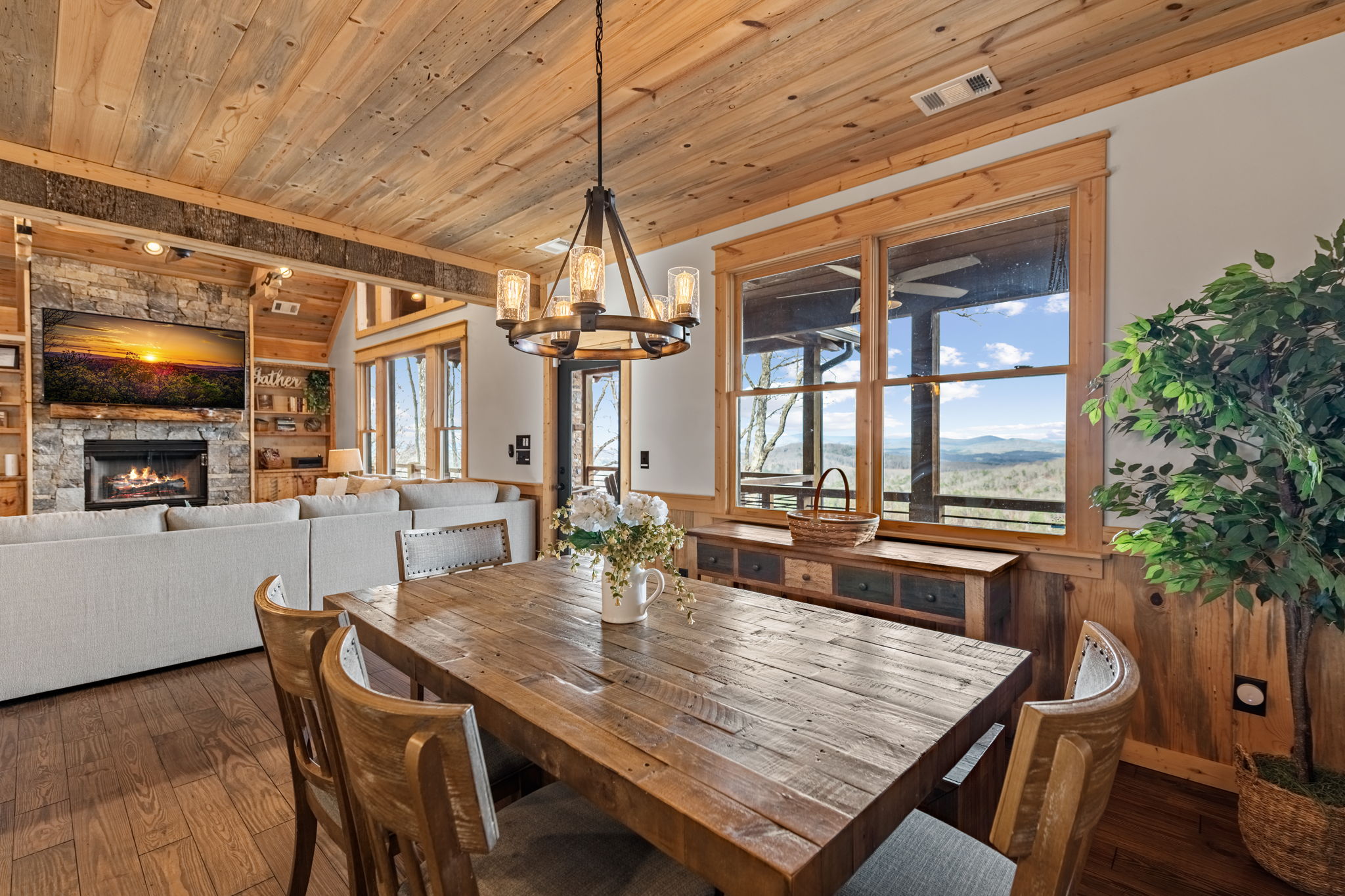 Dining area with chandelier and mountain views through windows