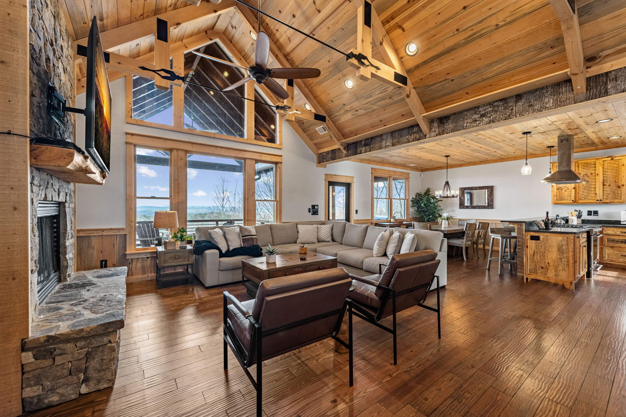 Open floor plan showing living dining and kitchen with vaulted ceiling