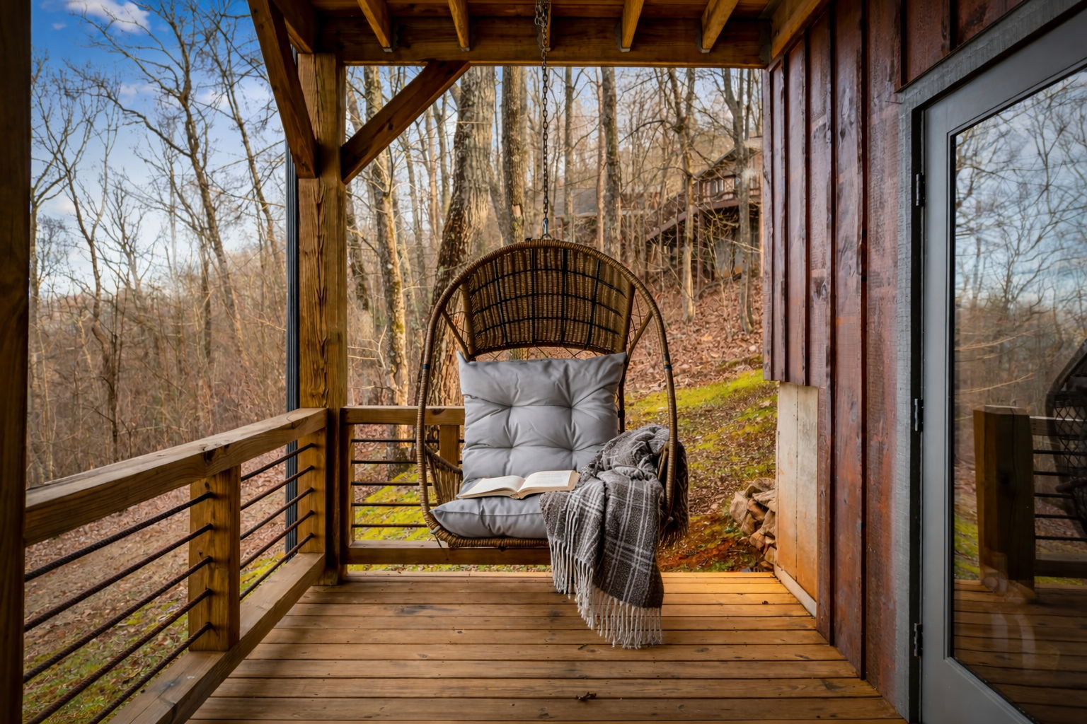 Cozy hanging chair reading nook on covered deck at Blue Ridge Georgia mountain cabin